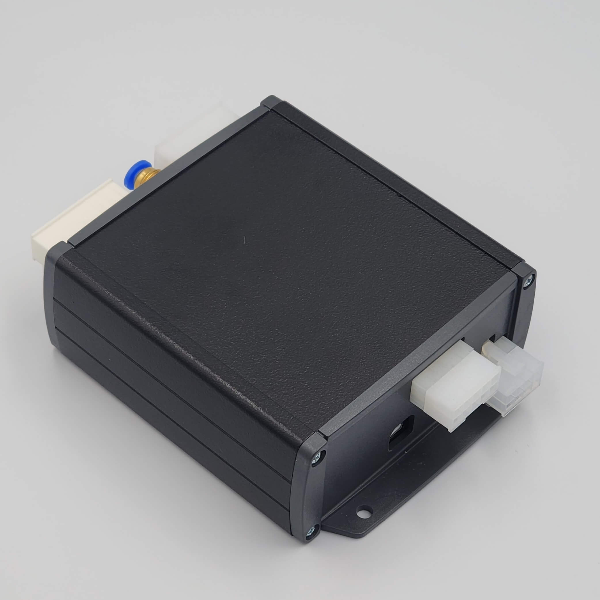 Black rectangular device with blue switch, white connectors.