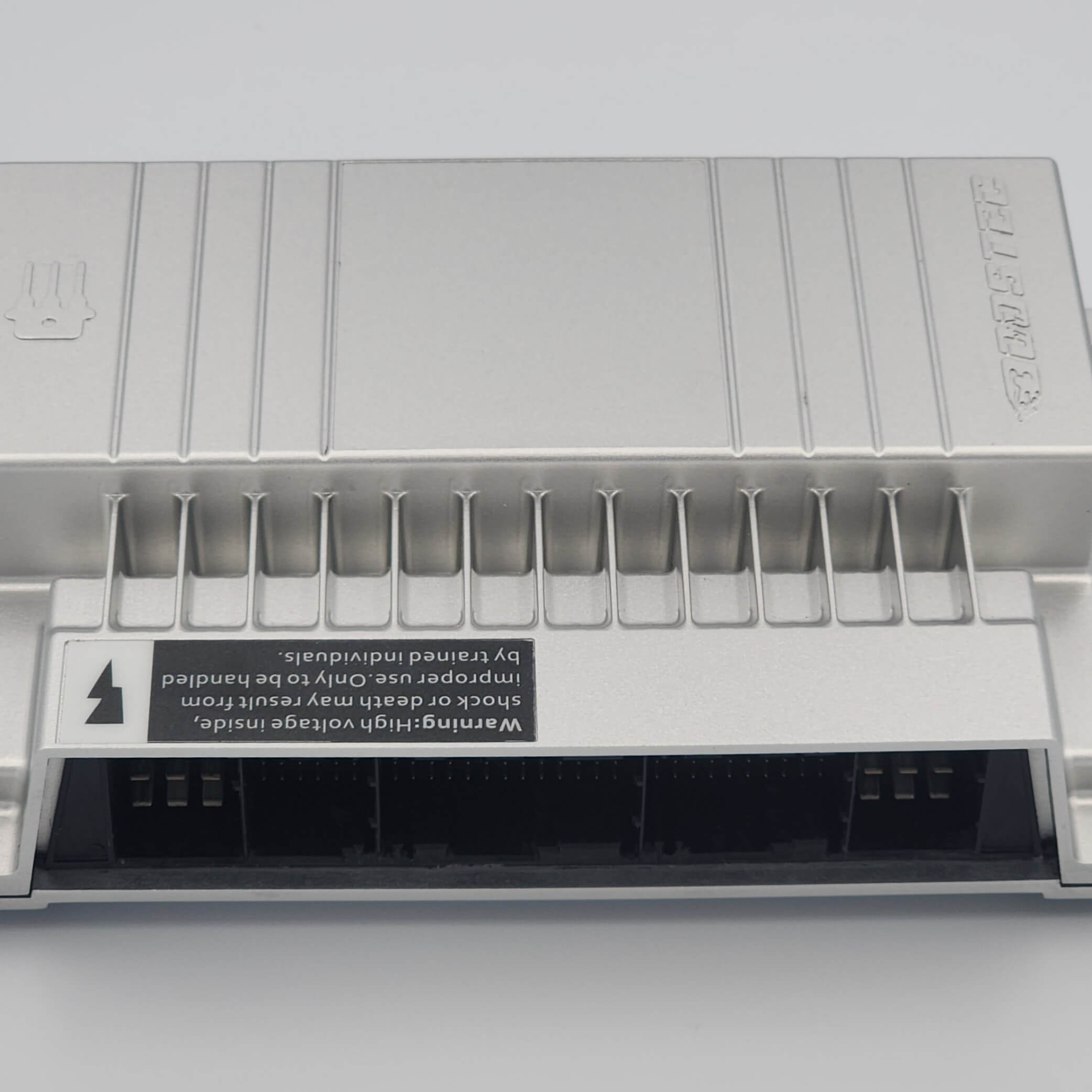 Close-up of silver network switch with labels, warnings, and ports.