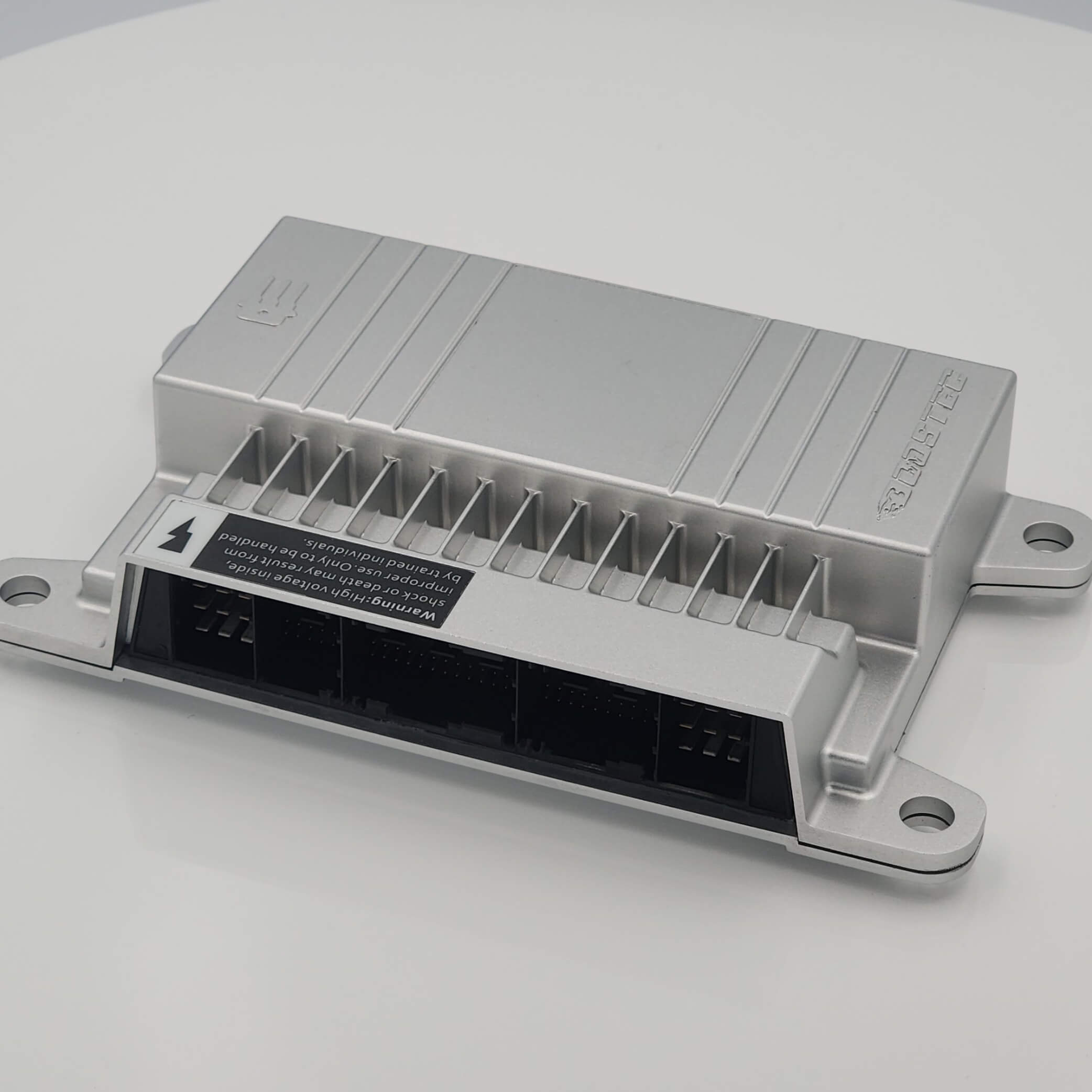 Gray industrial device with ports, labels, and metal casing on white.