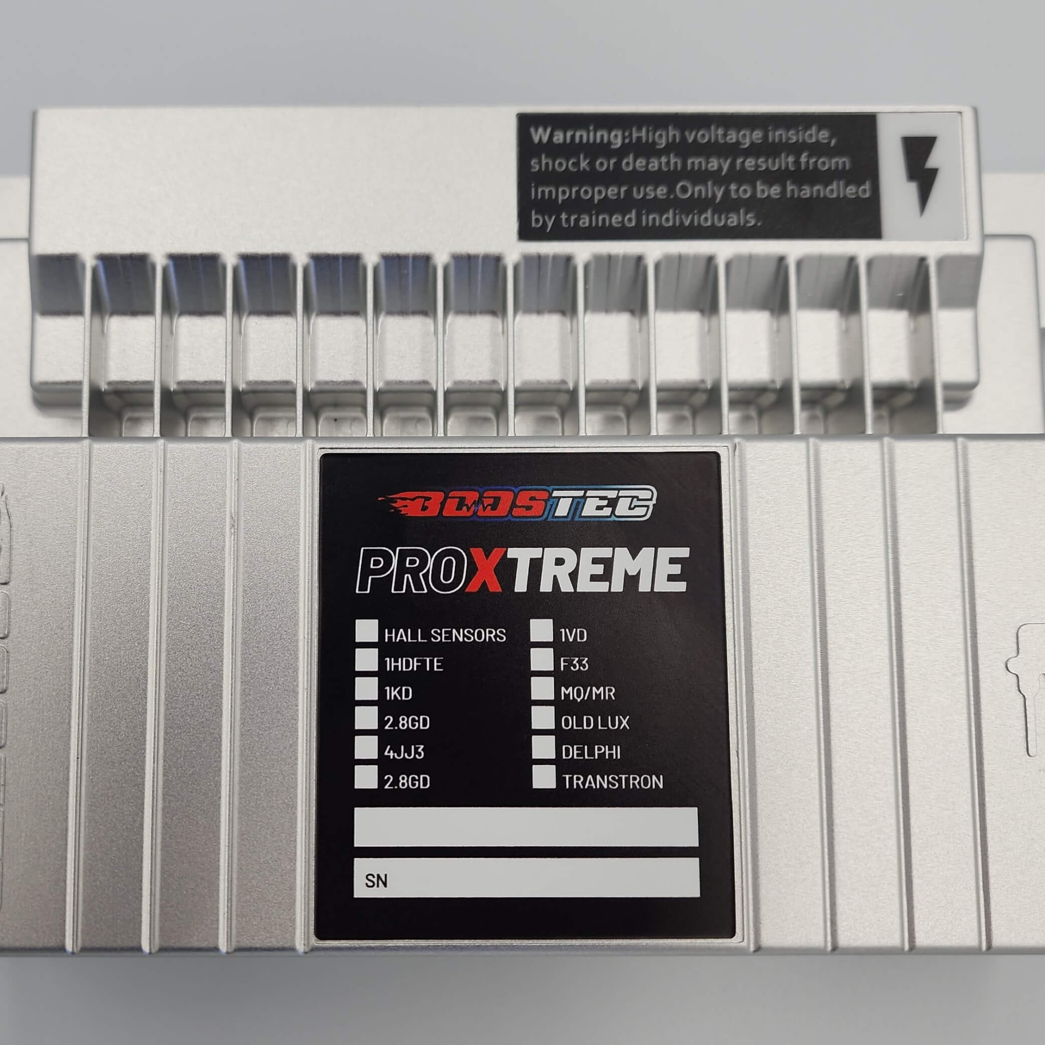 ProXtreme device with specs and high voltage warning in metal case.