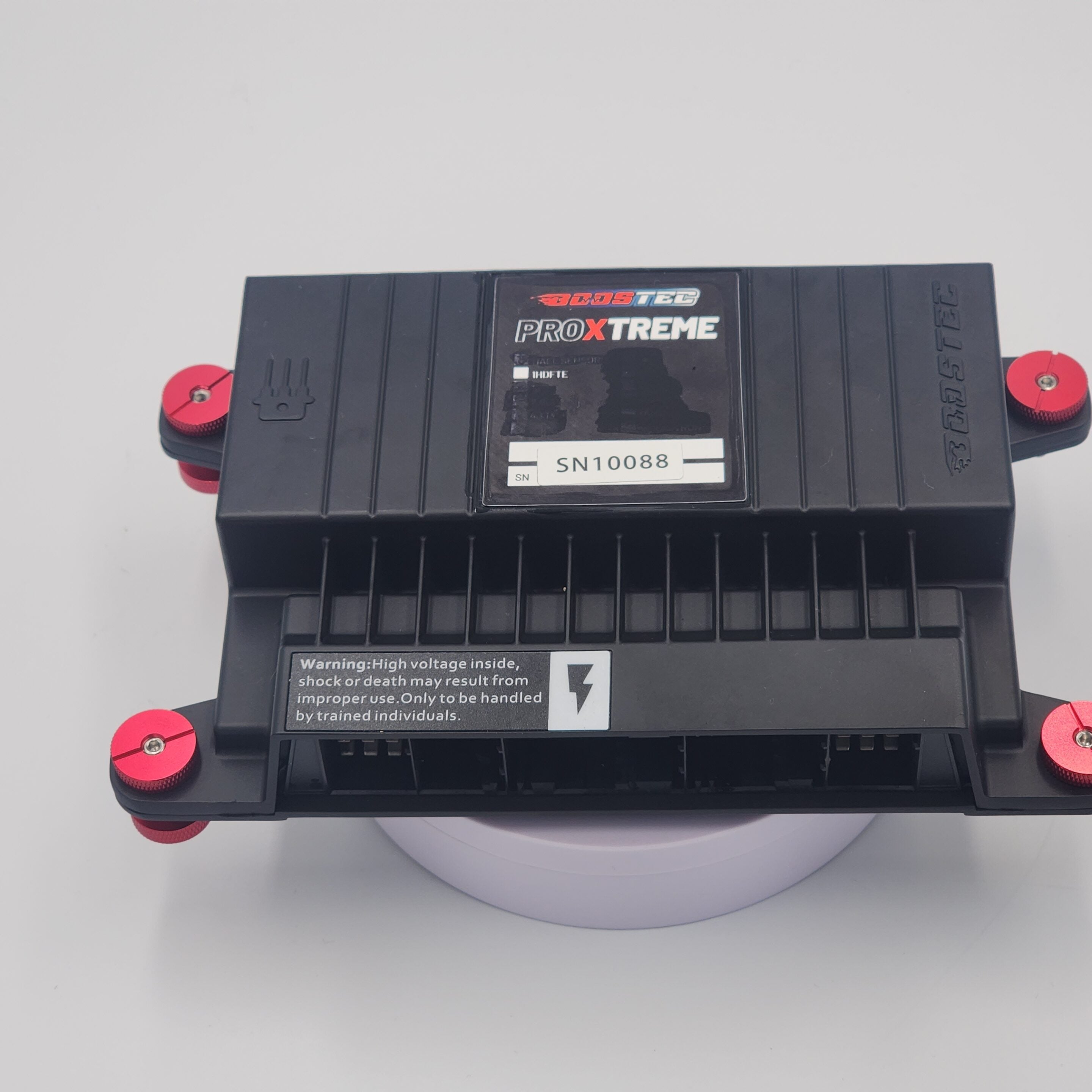 20240528_121745 ProXtreme black module with red fasteners and warning label.