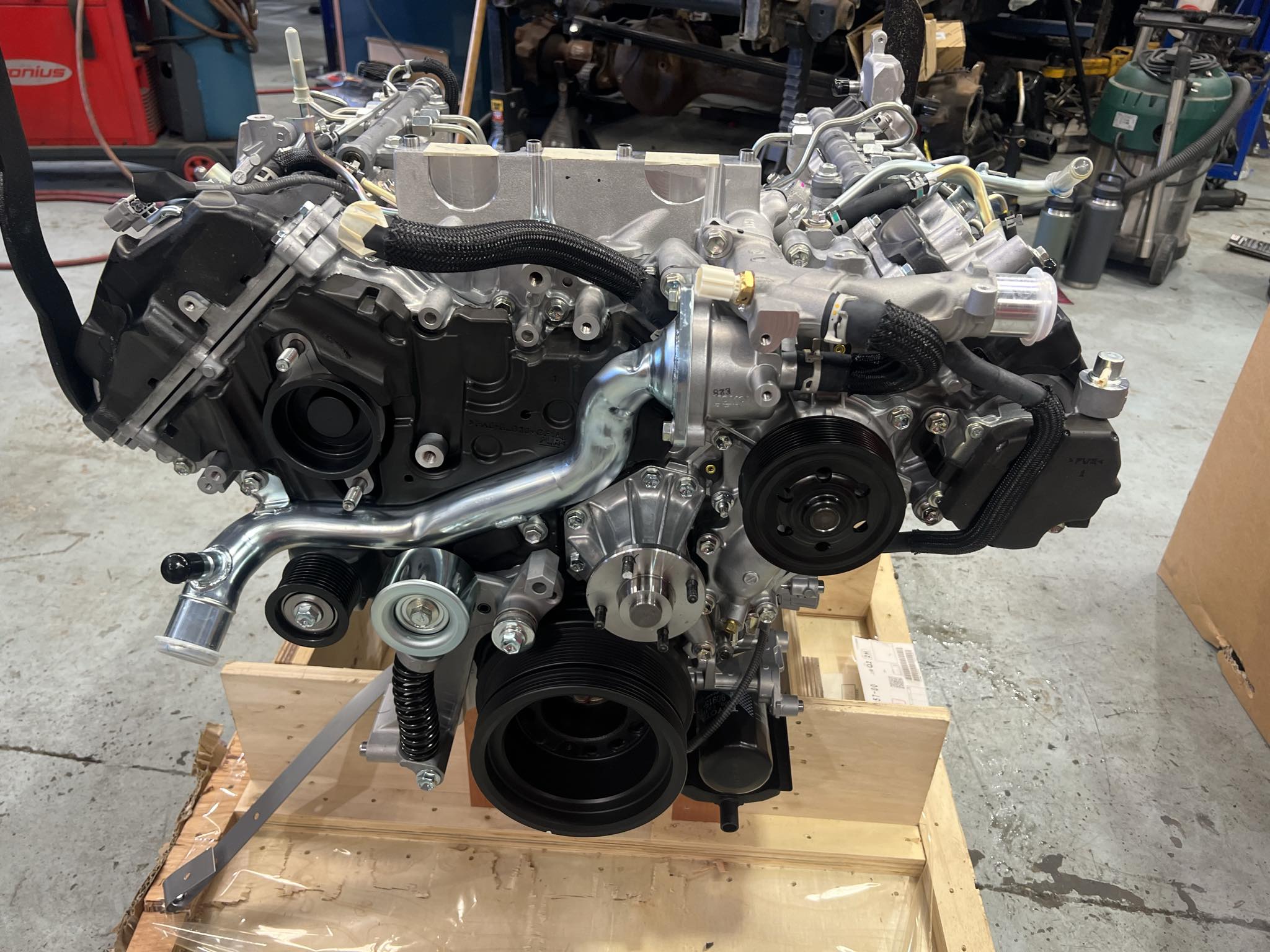 side view of a detailed engine assembly on a crate.