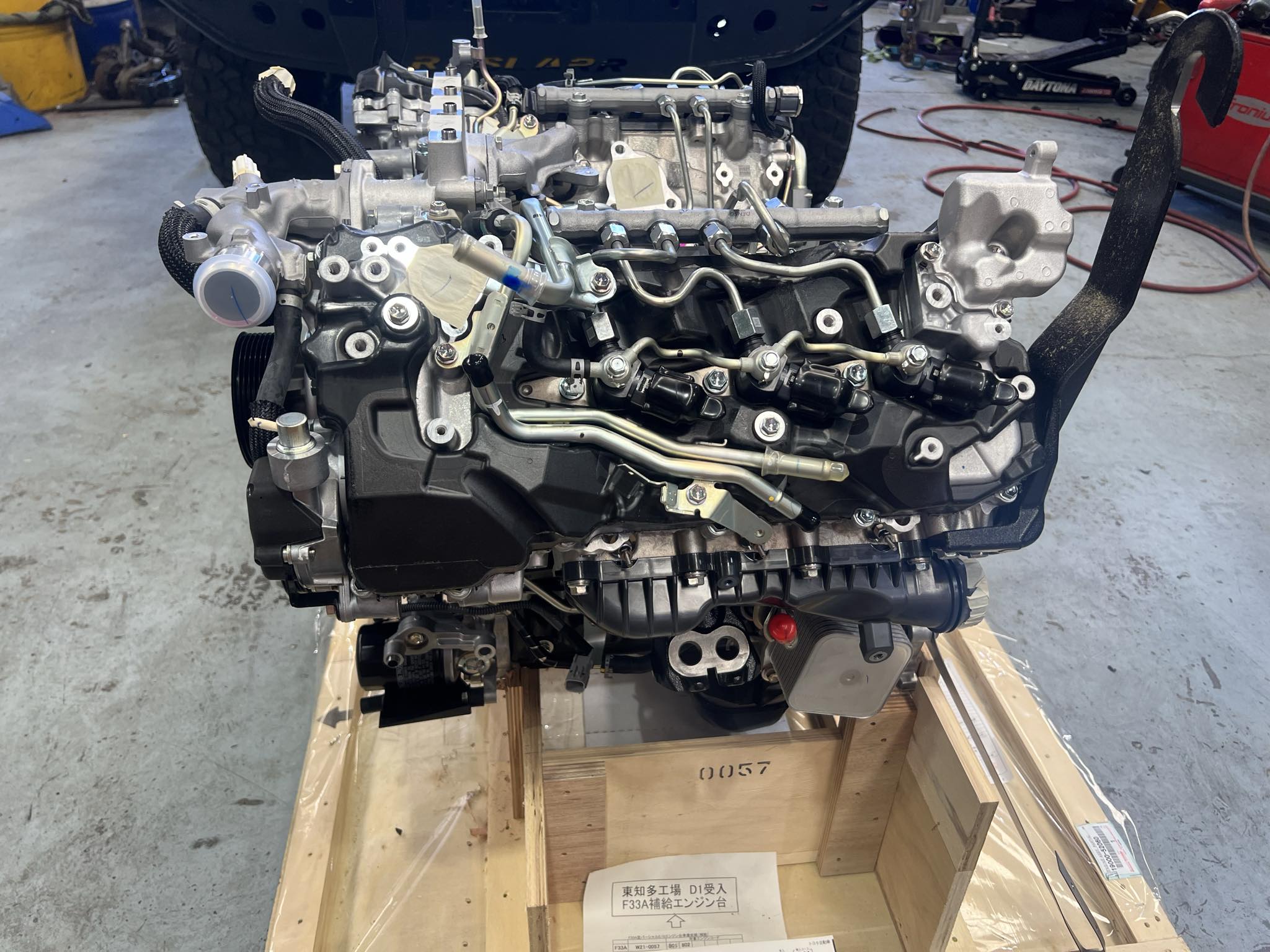 Detailed view of an engine mounted on a crate.