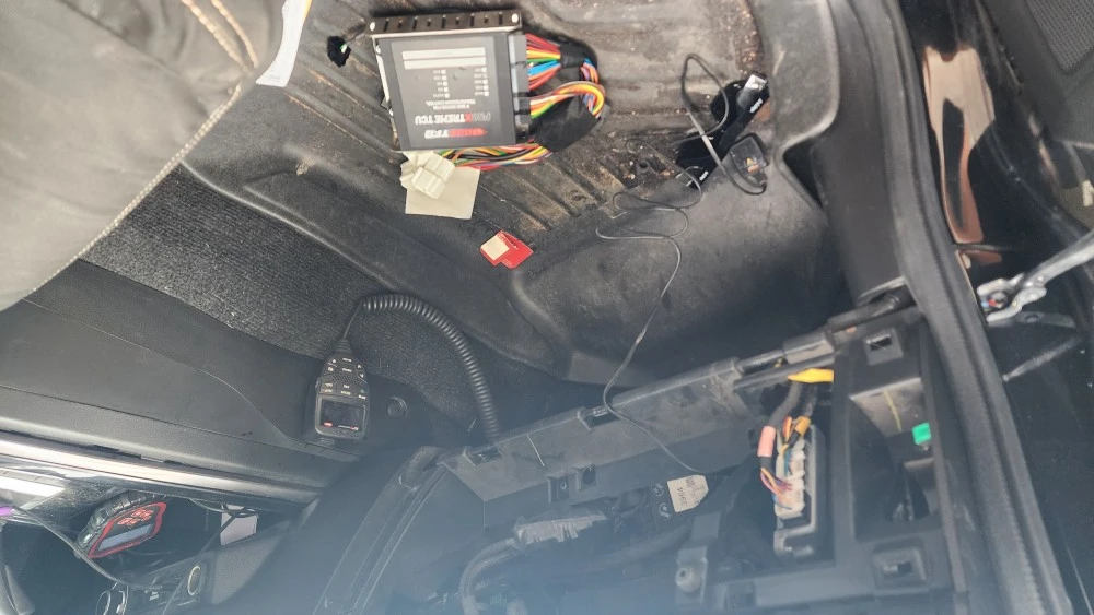 Vehicle interior with exposed wiring, radio, and Tundra rods.