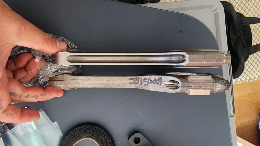 Hand holding two Tundra 700hp+ Billet Rods with 'MYSTIC' etch.